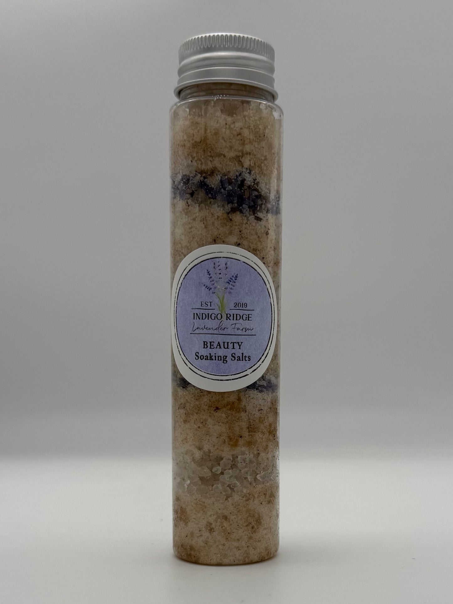 Tube of Indigo Ridge Beauty Soaking Salts with a label on a white background